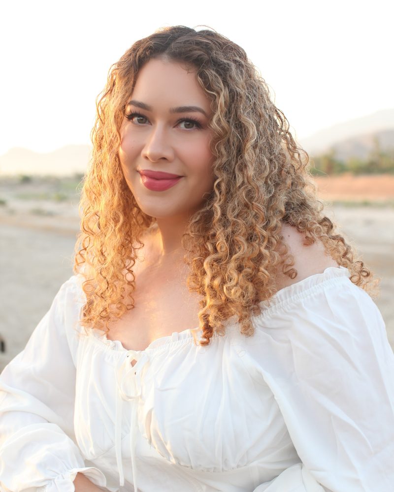 Portrait of LeAura Luciano at golden hour in a white top